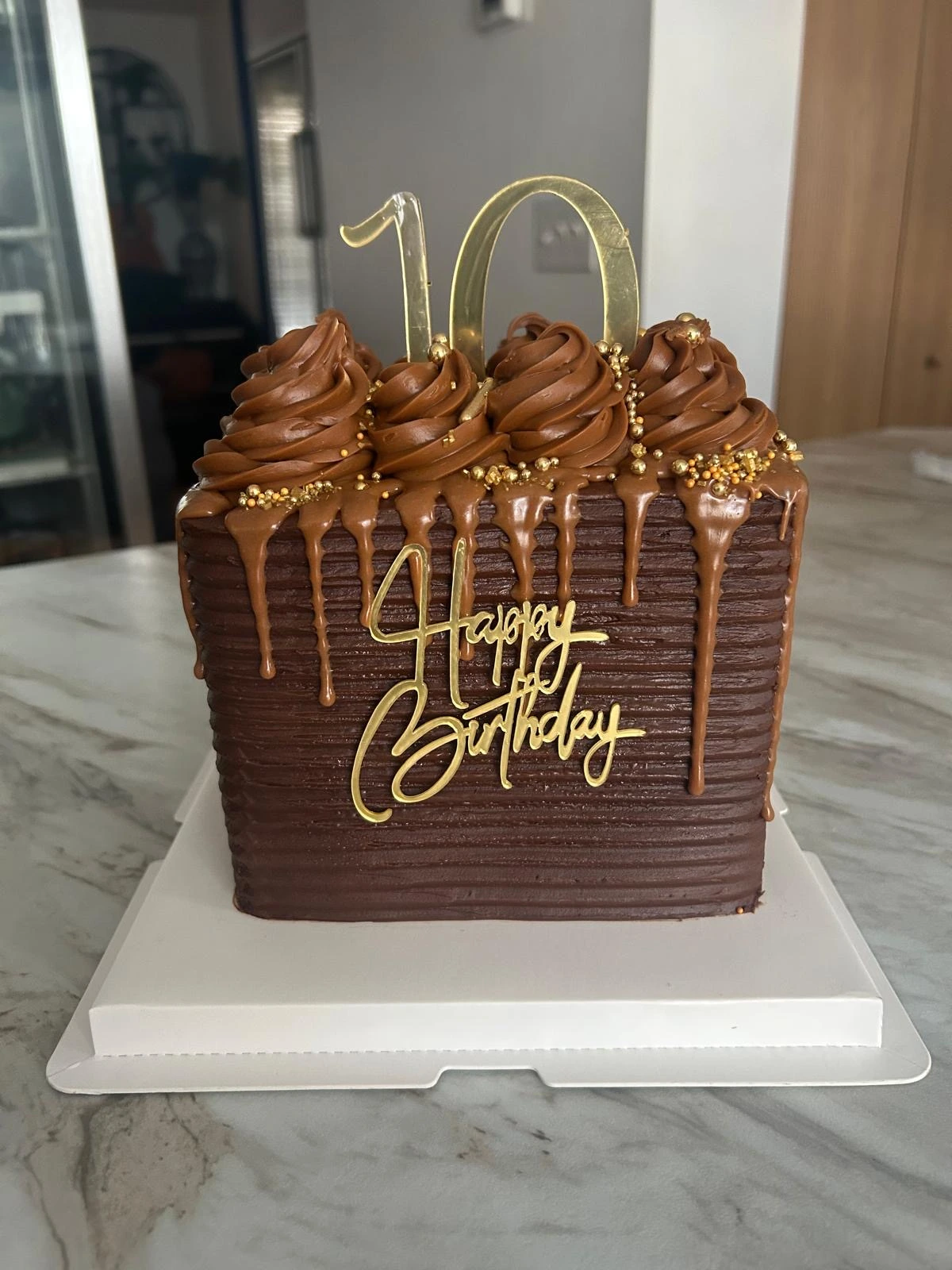 Chocolate birthday cake with piped details