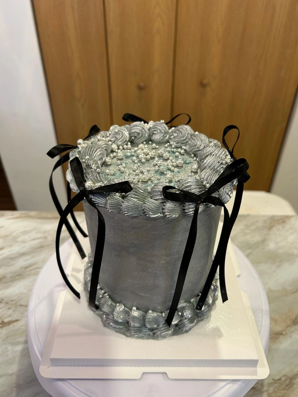 Silver cake with black ribbon details