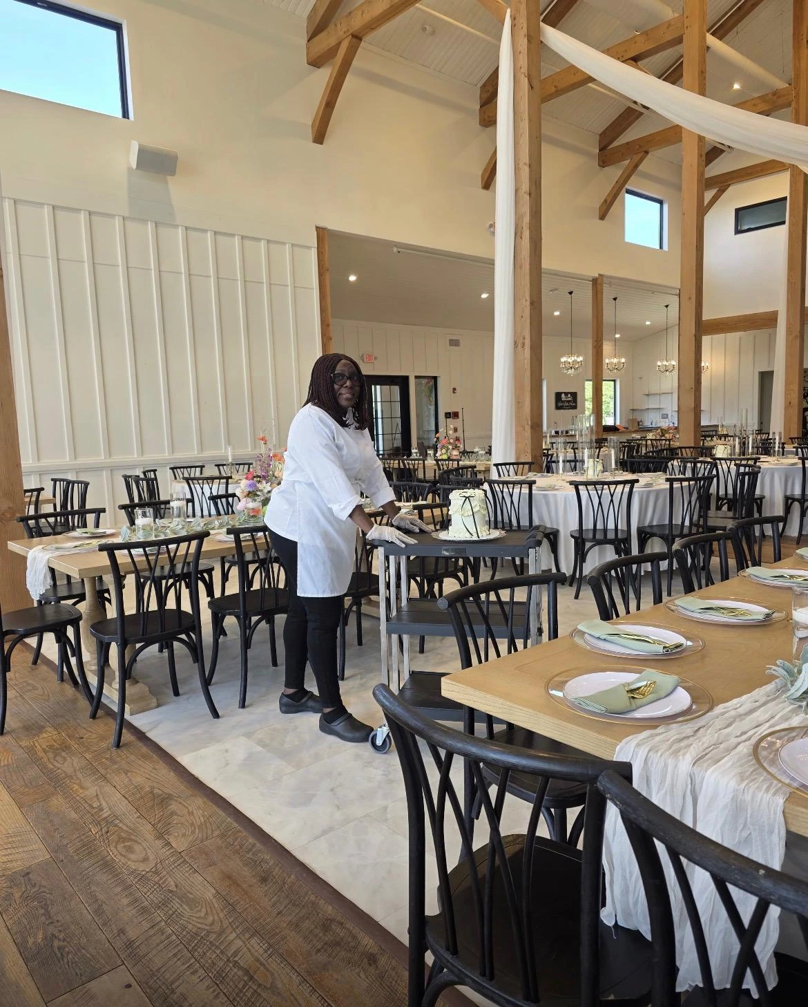 Debby preparing a cake for an event at a reception venue