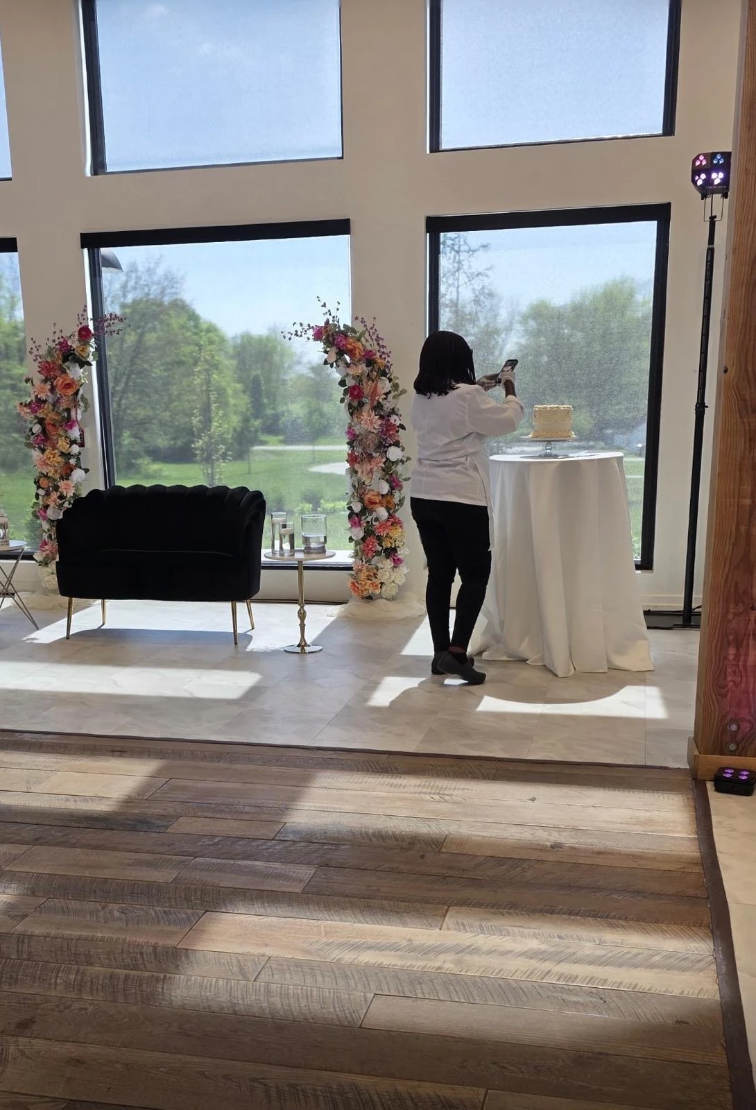 Debby photographing a finished cake at a wedding venue
