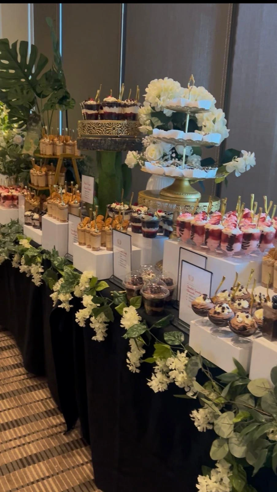 Debby’s event dessert table with layered cups and decorated cake stands