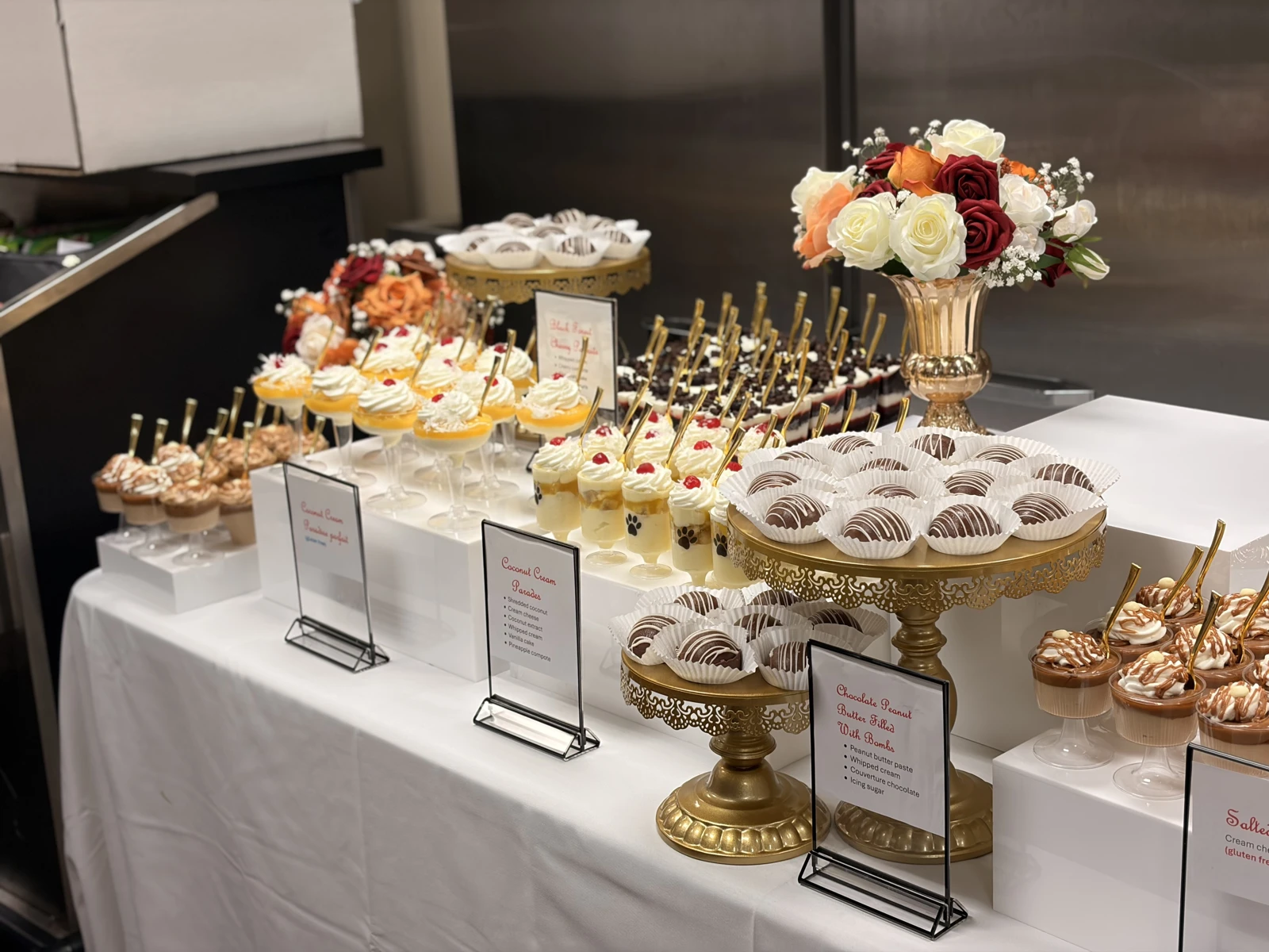 An event dessert table featuring cakes and small desserts