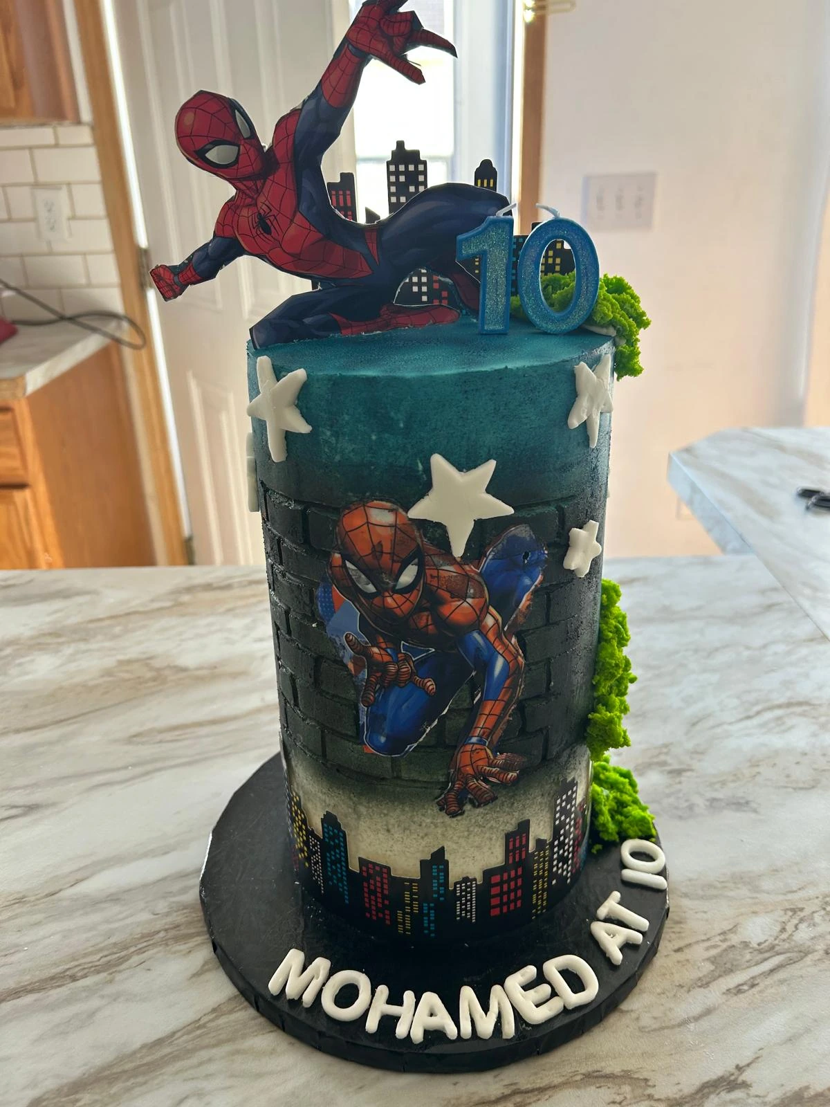 Spider-Man birthday cake with a city skyline