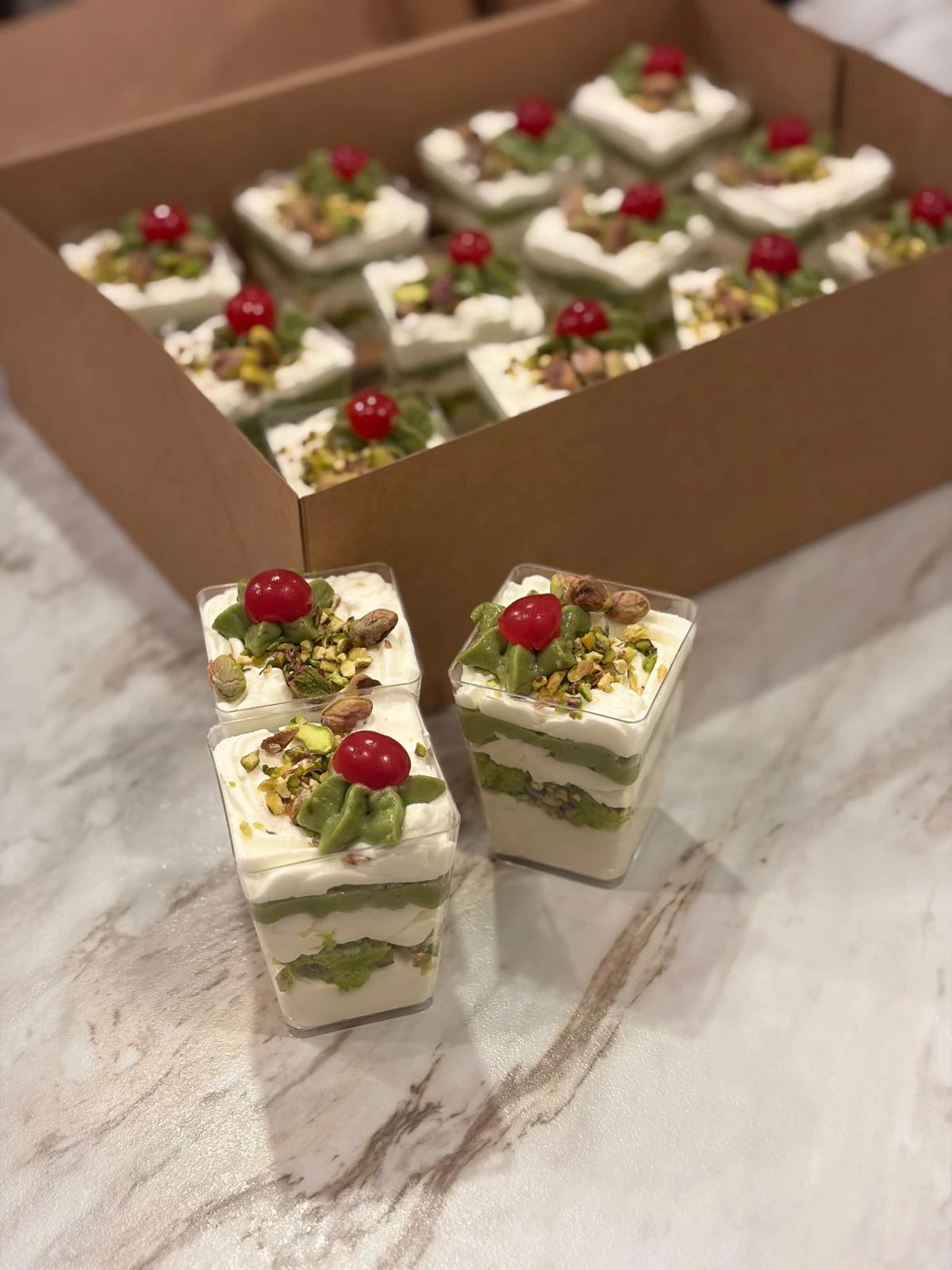 Layered parfait cups with cherry finishes