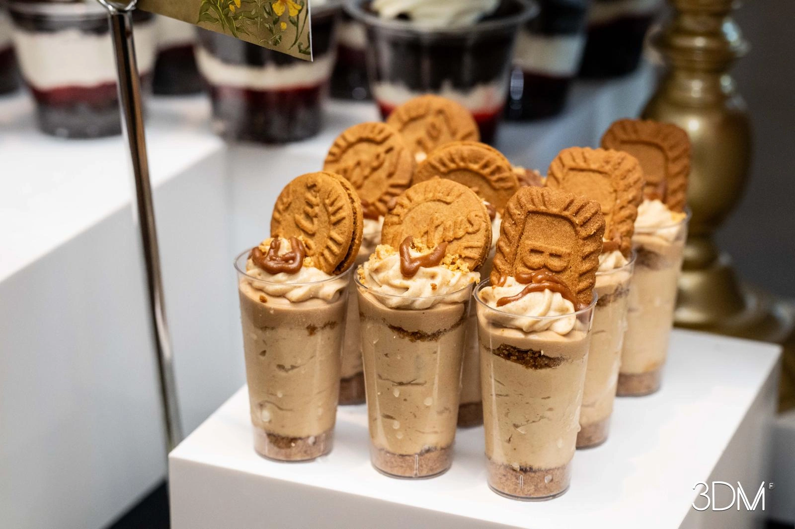 Beautifully layered parfaits with biscuit toppings and gold spoons