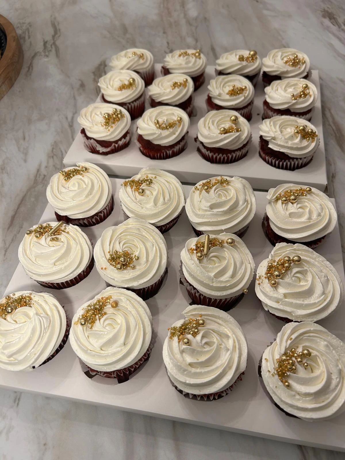Cupcakes with cream swirls and gold finishing details